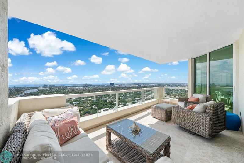 a living room with furniture and a floor to ceiling window