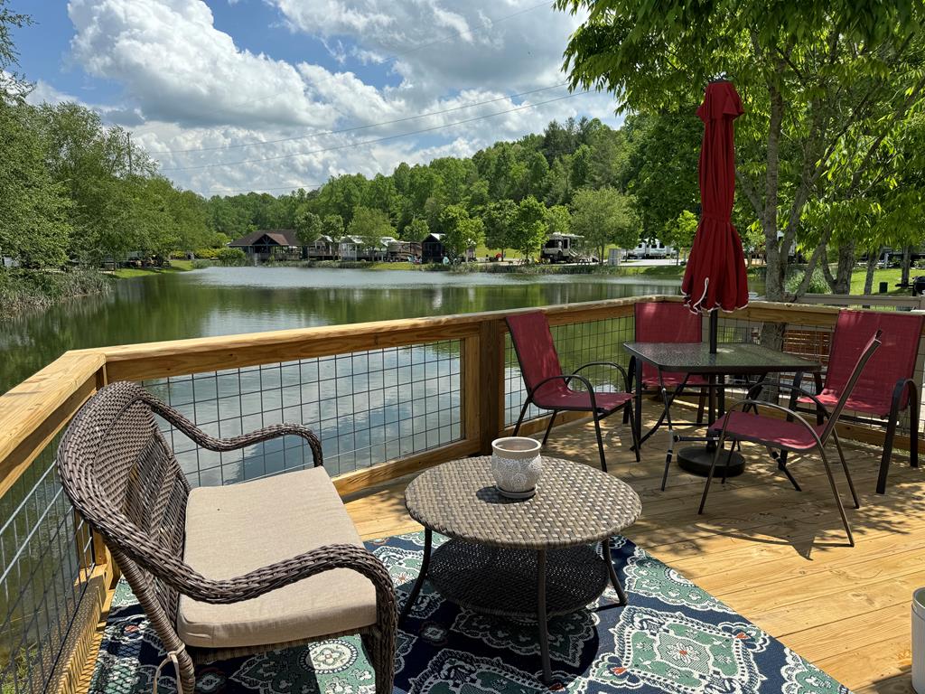 a outdoor sitting area with furniture and lake view