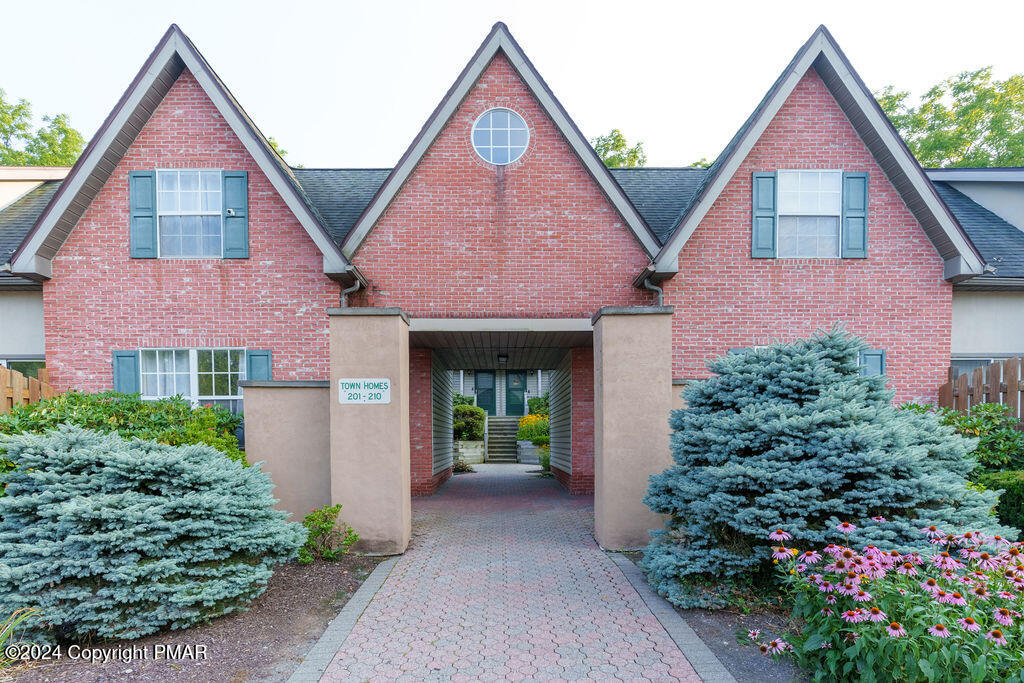 a front view of a house with garden