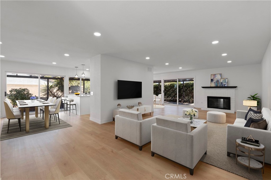 a living room with furniture flat screen tv and a fireplace