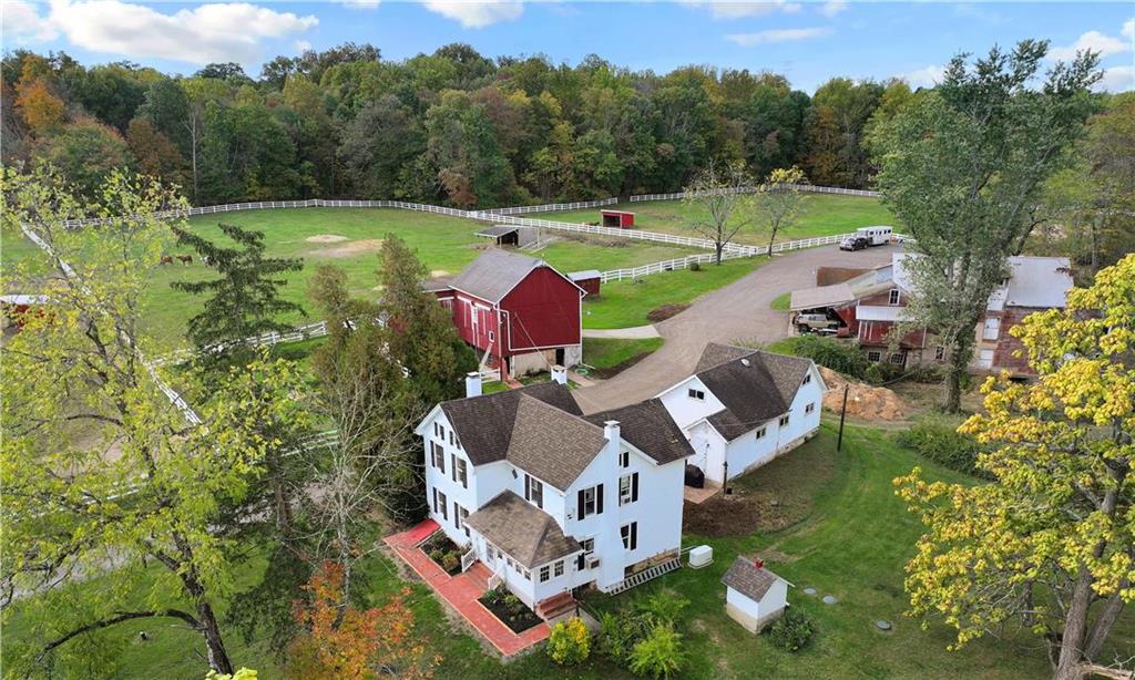 an aerial view of residential house with outdoor space and swimming pool