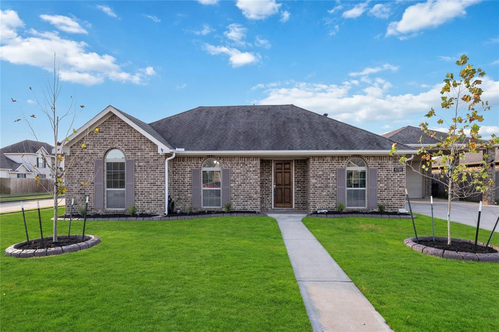 a front view of a house with a yard