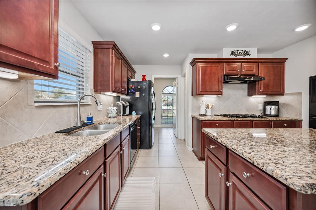 a kitchen with stainless steel appliances granite countertop a counter and a sink