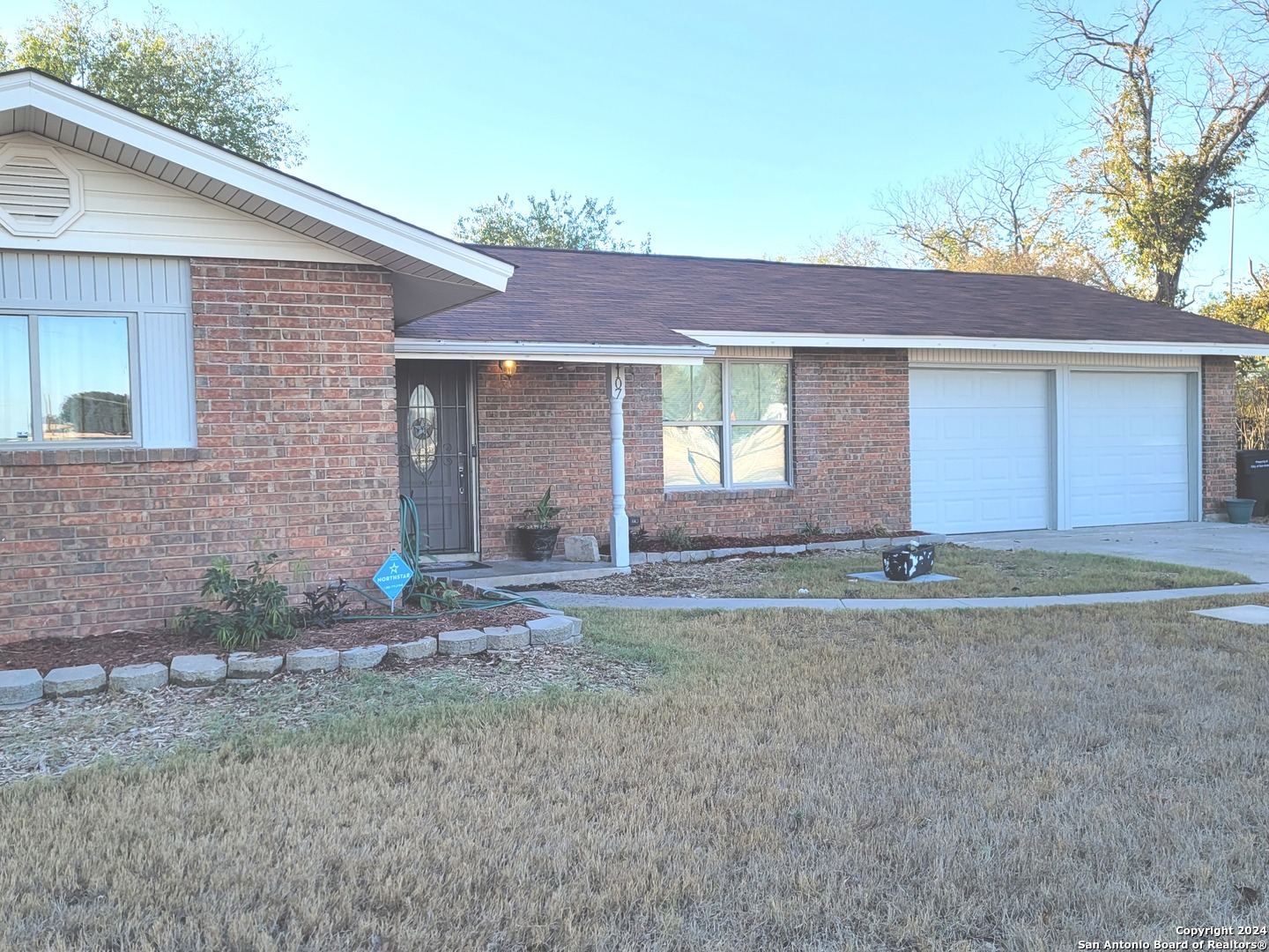 a front view of a house with a yard and garage