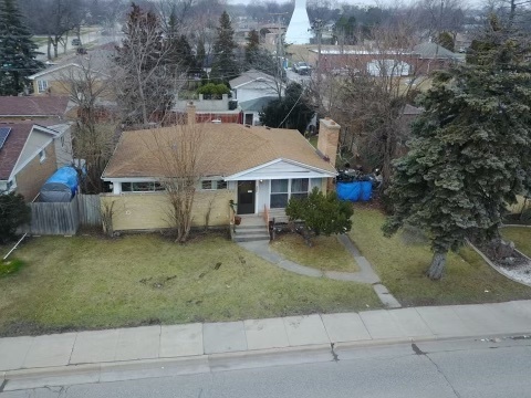 an aerial view of a house with a yard