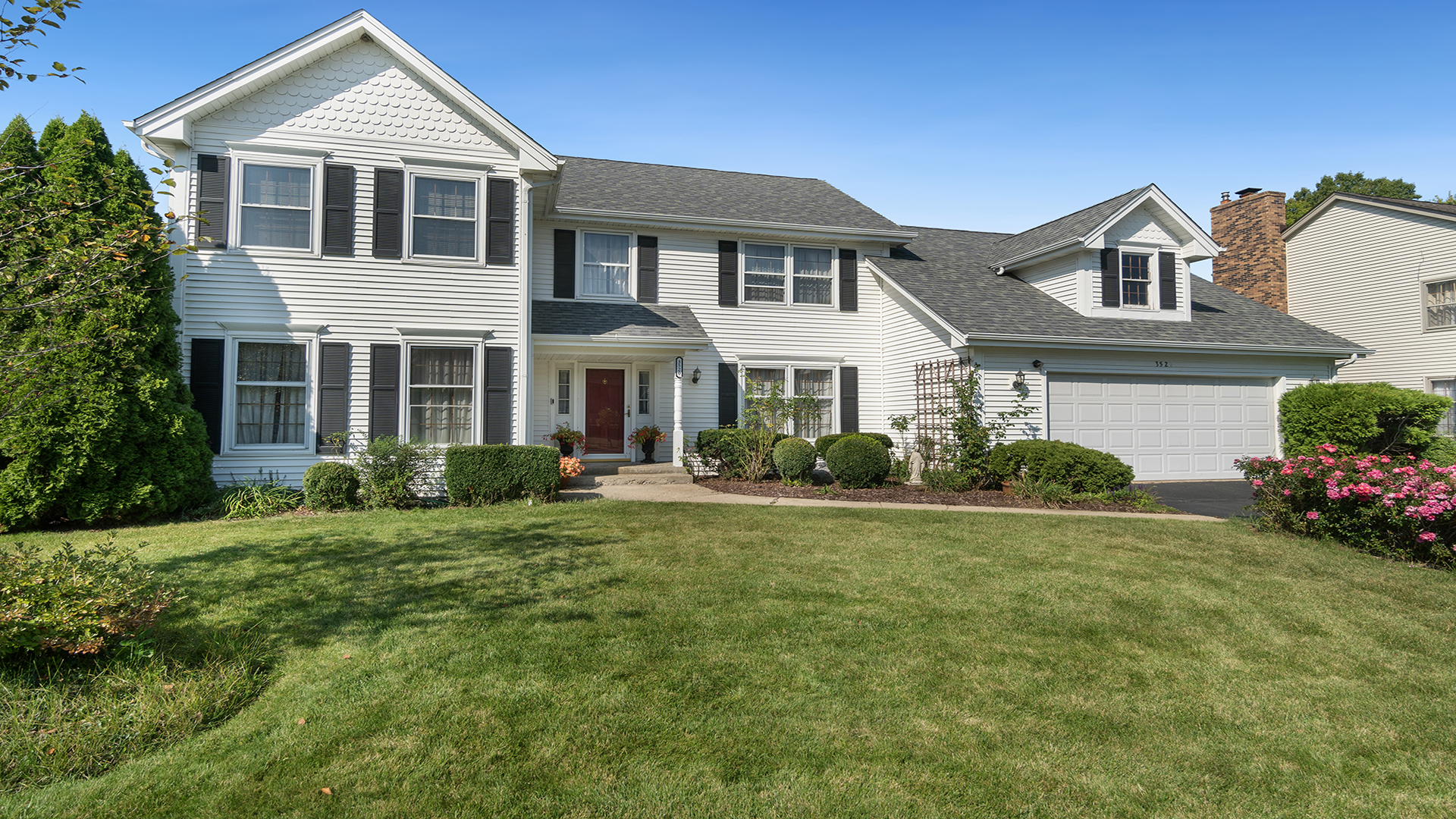 a front view of a house with a yard