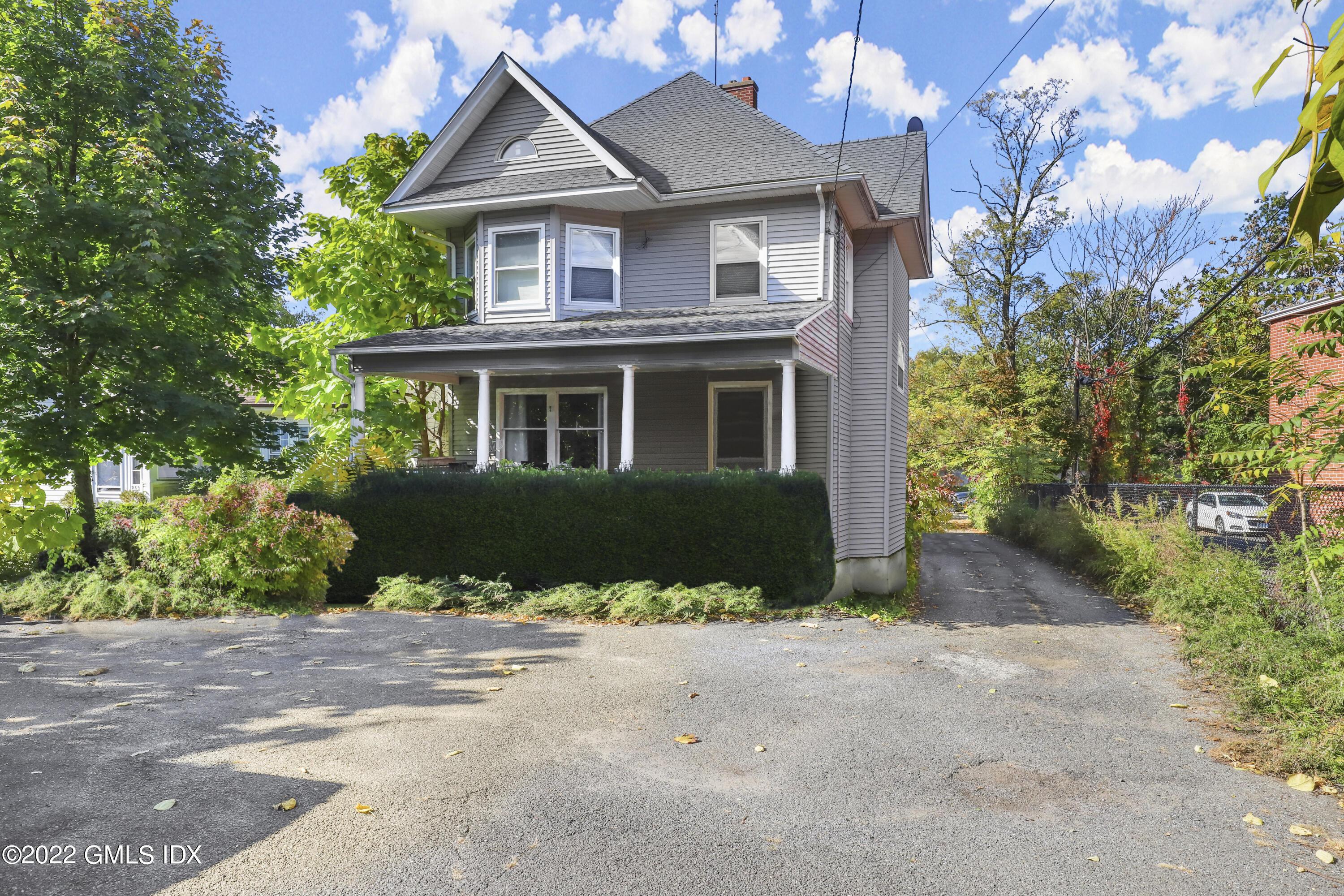 a view of a house with a yard and potted plants