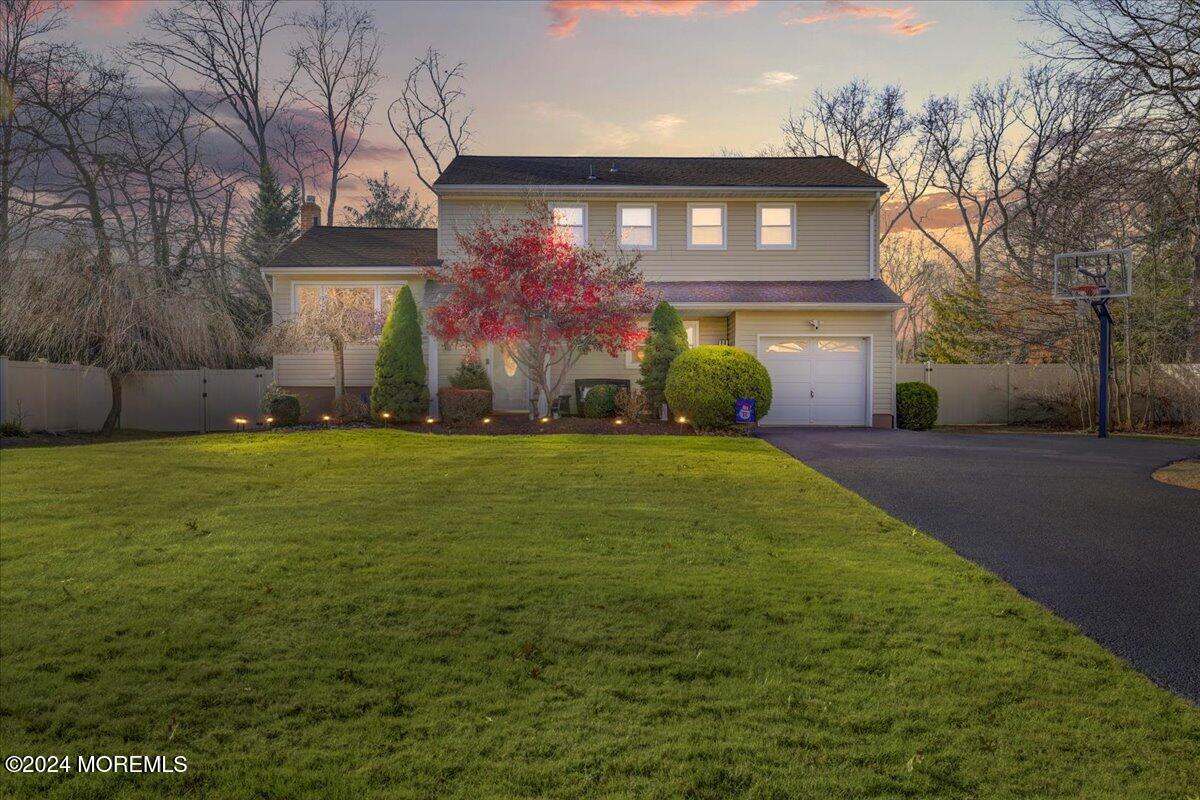 a front view of house with yard and trees