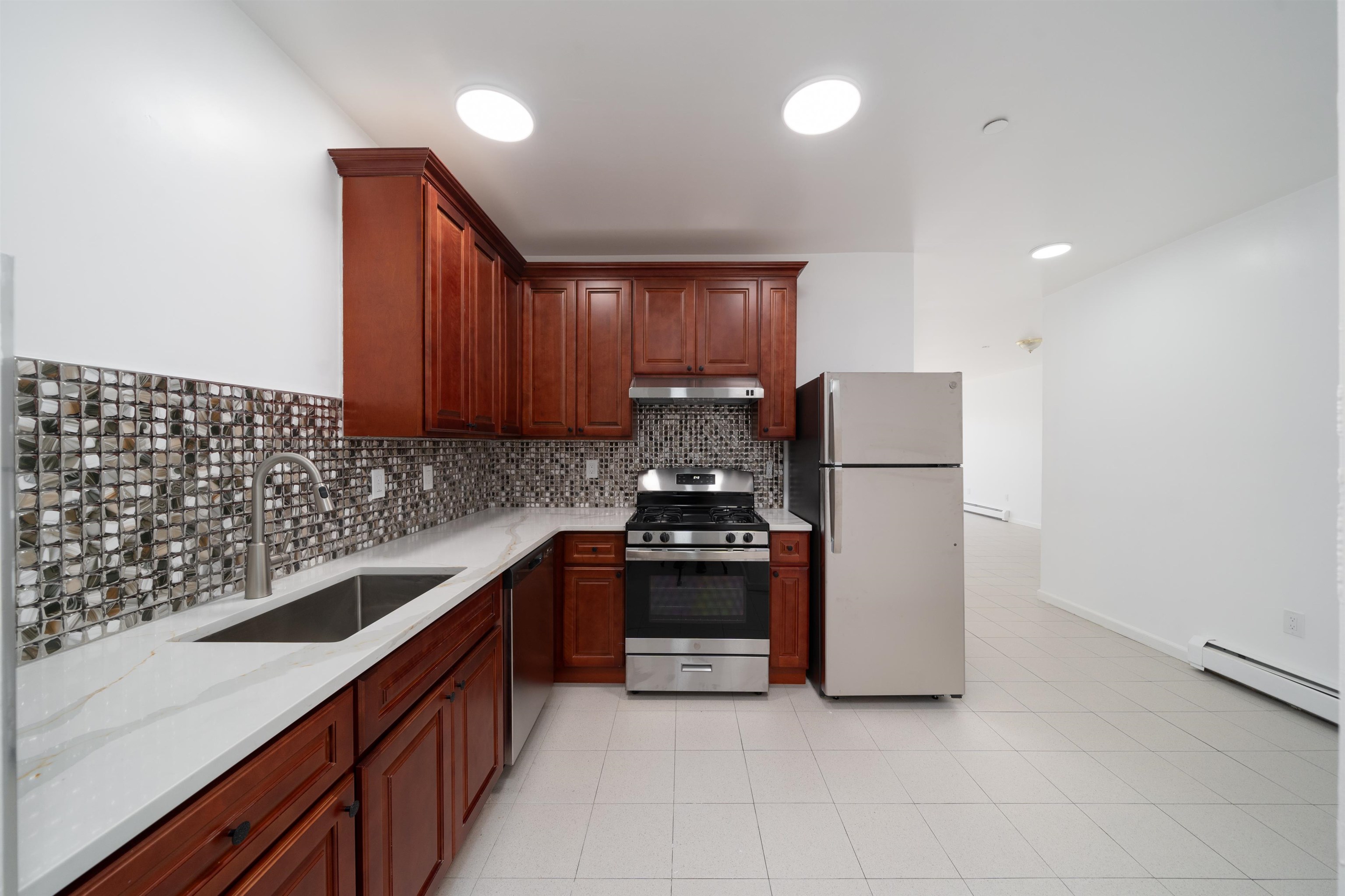 a kitchen with a sink and a stove top oven