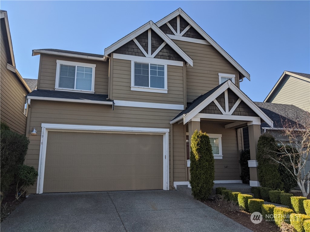 a front view of a house with garage