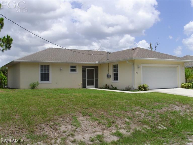 a view of a house with a yard and garage