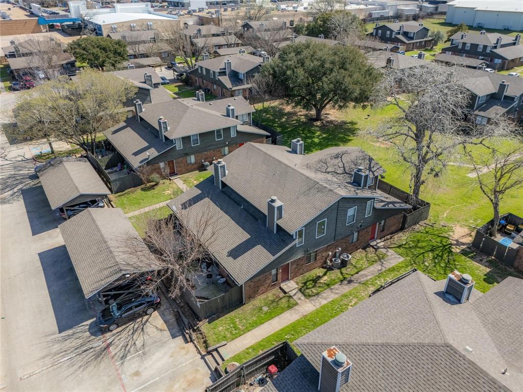 an aerial view of a house with garden space and street view