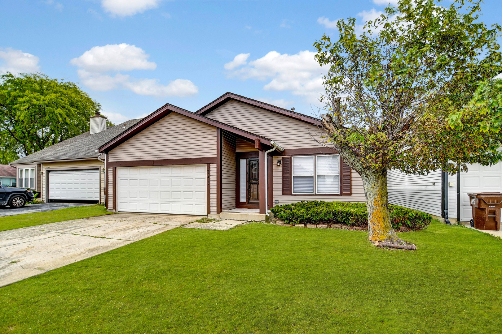 a front view of a house with a yard and garage