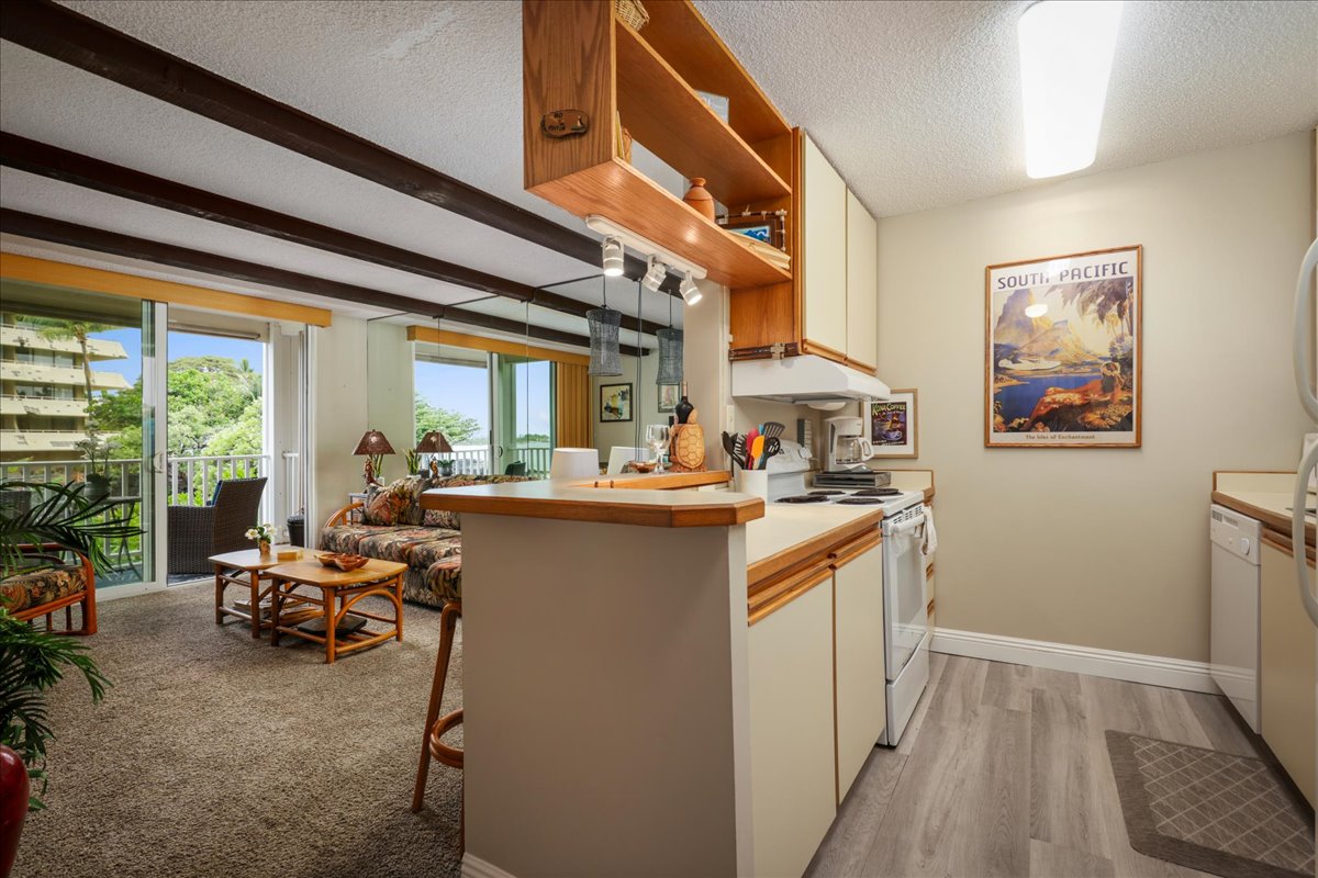 a kitchen with stainless steel appliances granite countertop sink stove and cabinets