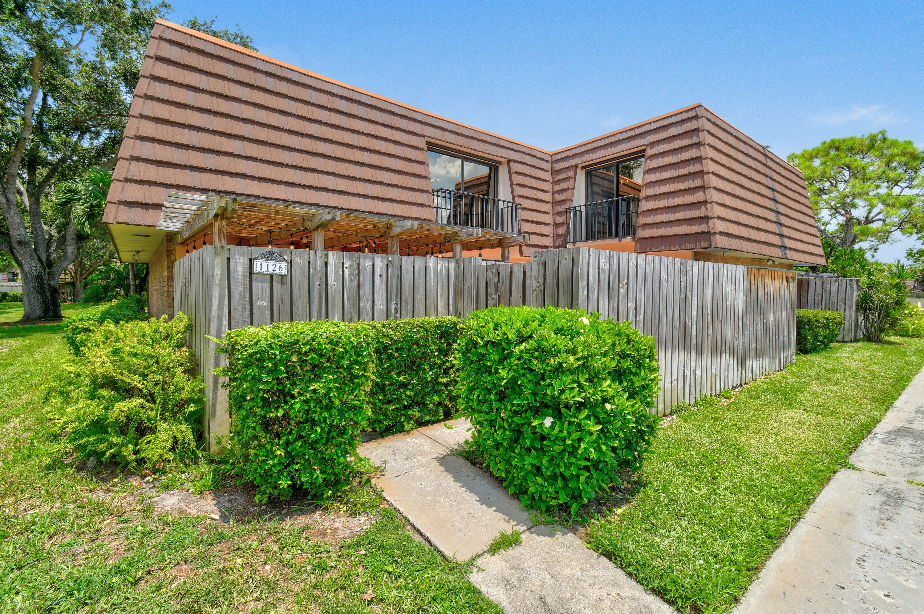 a front view of a house with garden