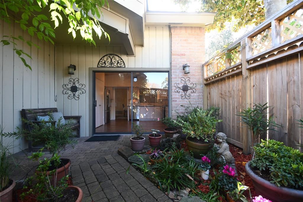 Welcome home each day through this charming courtyard from your secure, oversized garage!