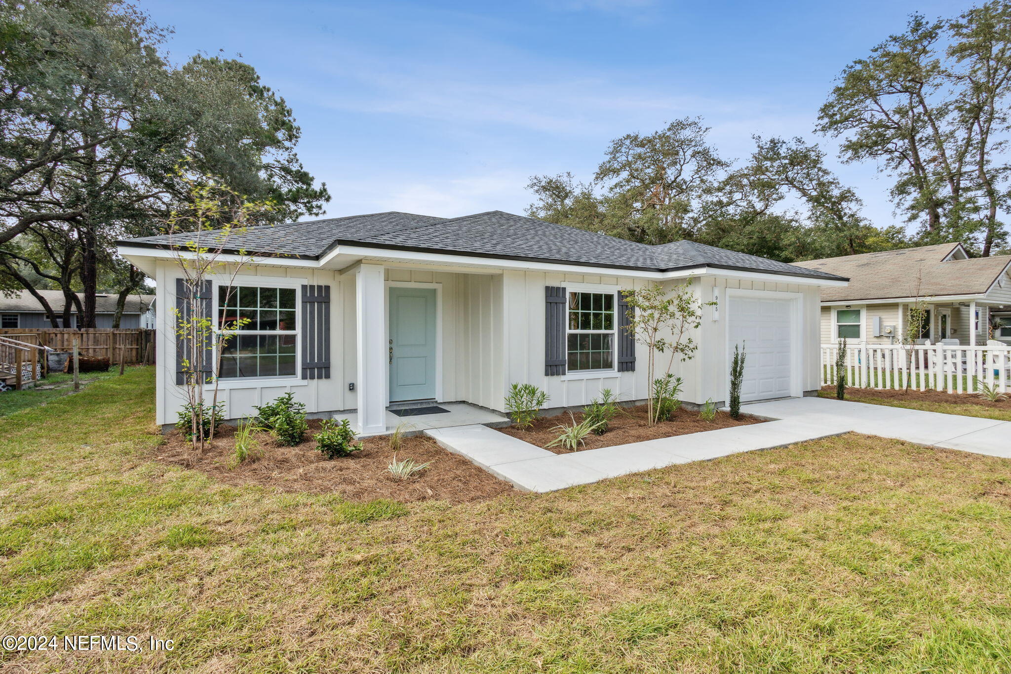 a front view of a house with a garden and patio