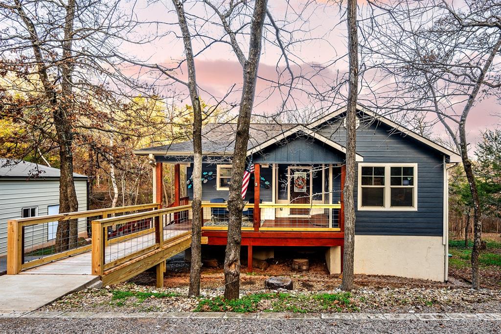 a backyard of a house with wooden deck and barbeque oven