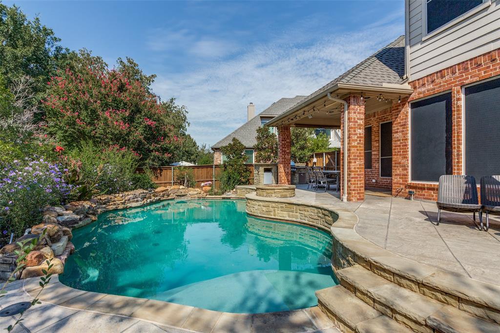 a view of a house with swimming pool and sitting area