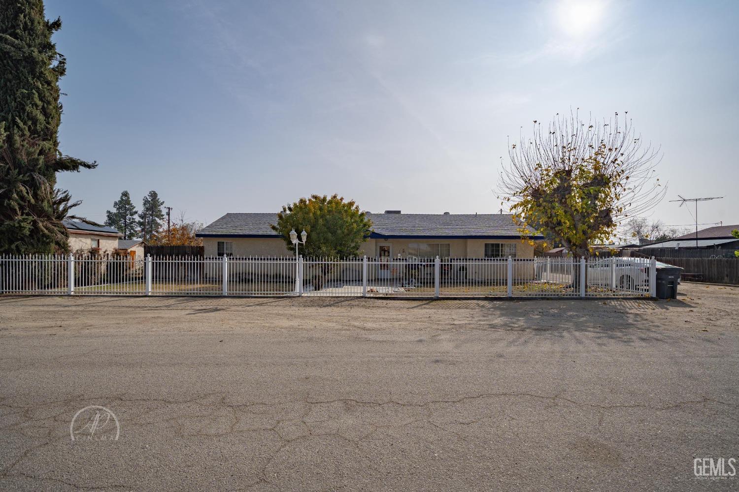 front view of a house with a yard and trees