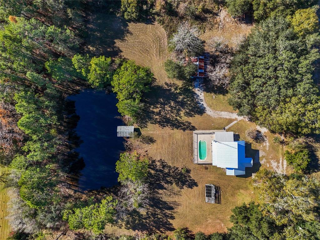 an aerial view of a house with yard