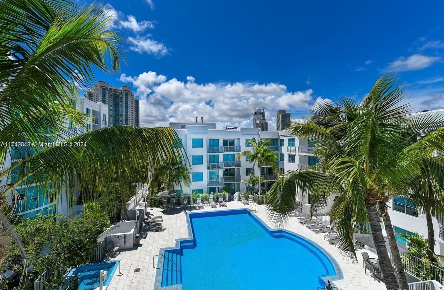 a view of swimming pool with outdoor seating and plants