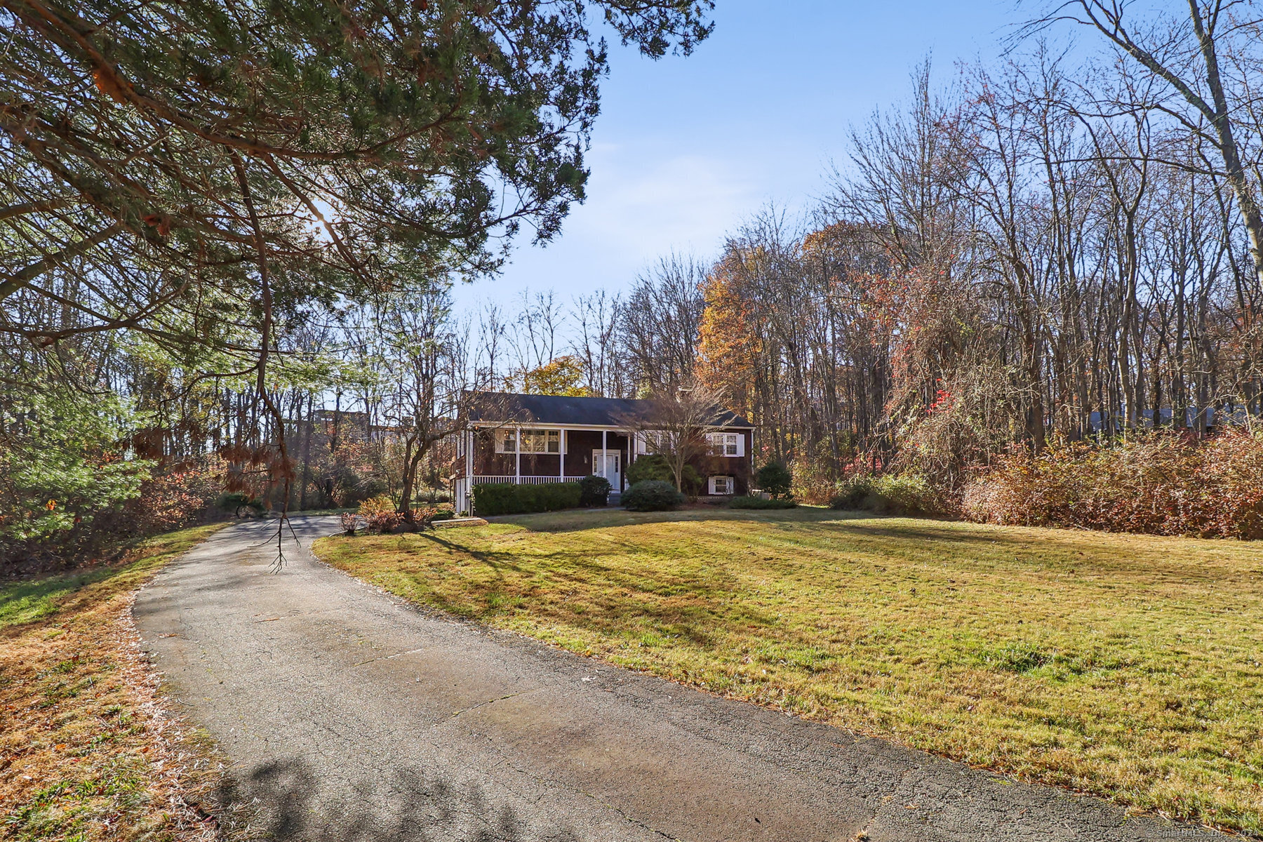 a view of a house with a yard covered with trees