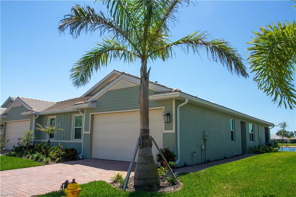 a front view of house with yard and green space