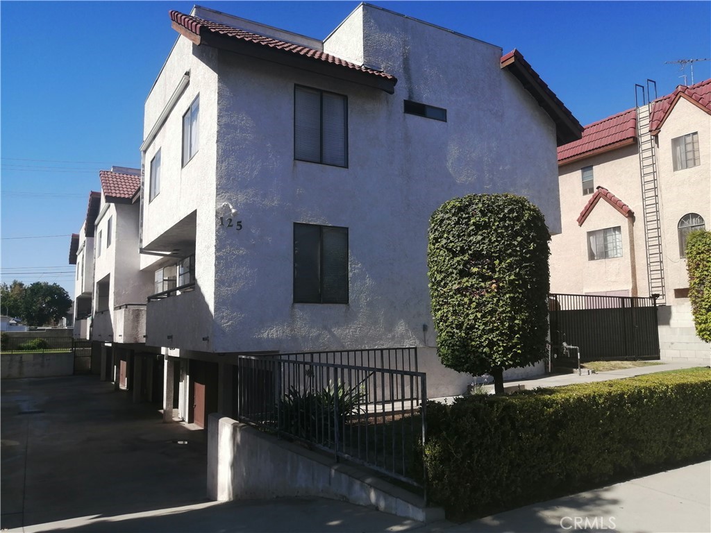 a front view of a house with plants