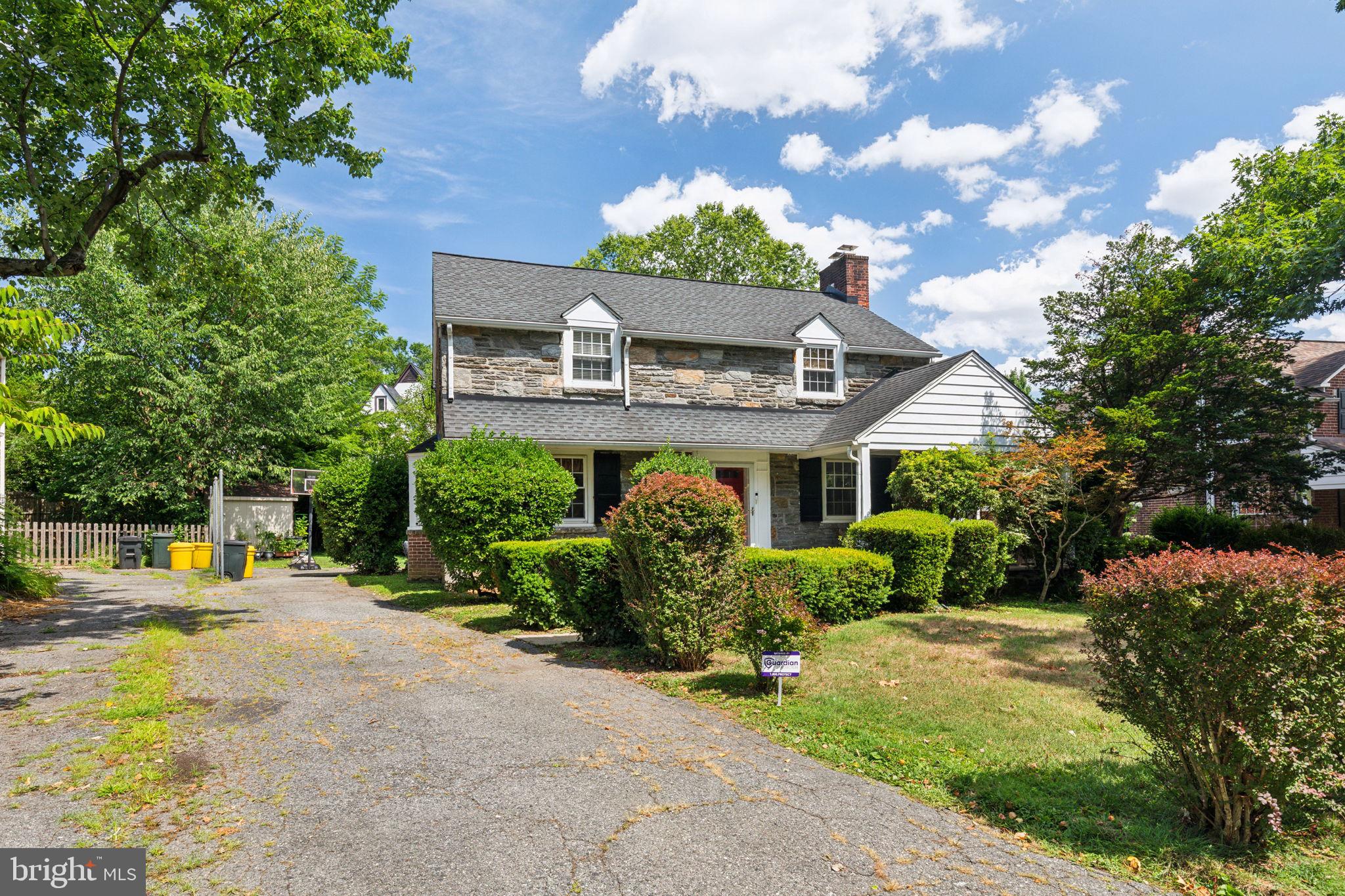 an aerial view of a house with a yard potted plants and large tree