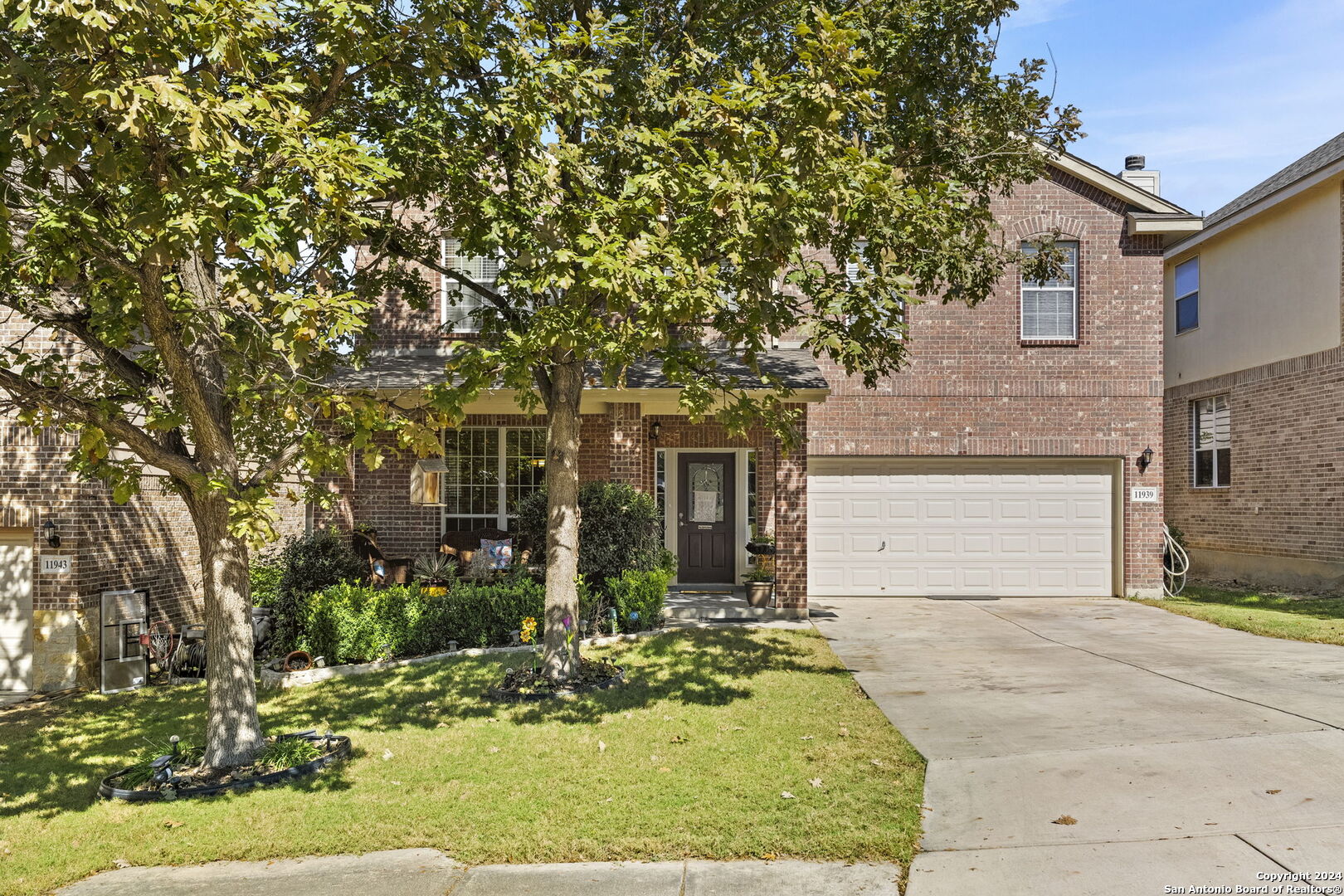 front view of a house with a tree