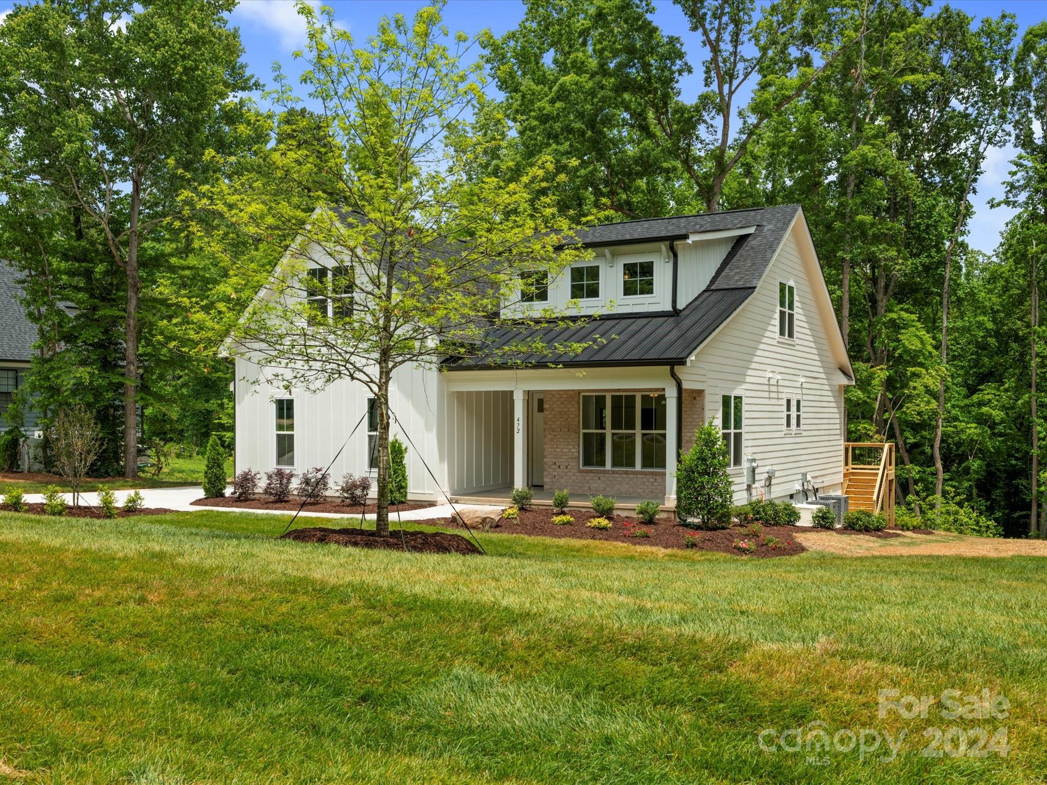 a front view of house with a yard and trees