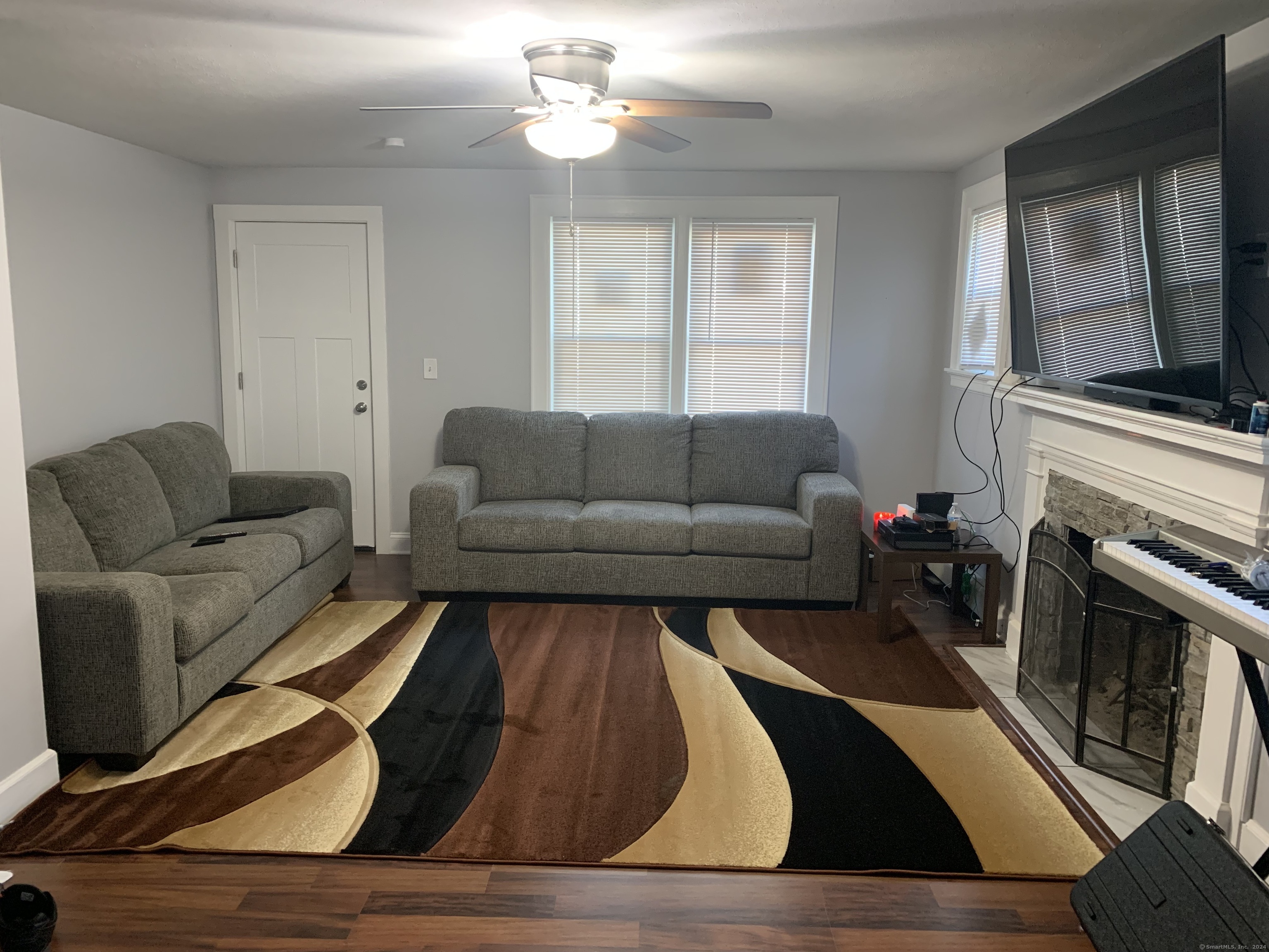 a living room with furniture and a fireplace