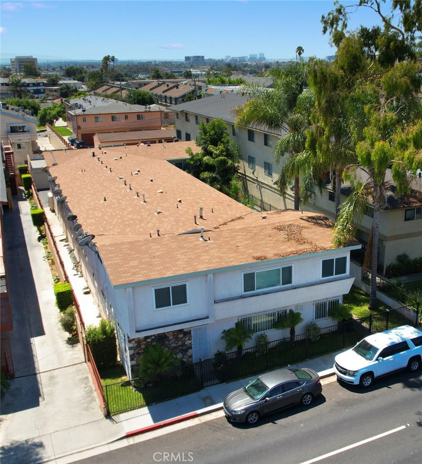 an aerial view of a house with garden space and street view