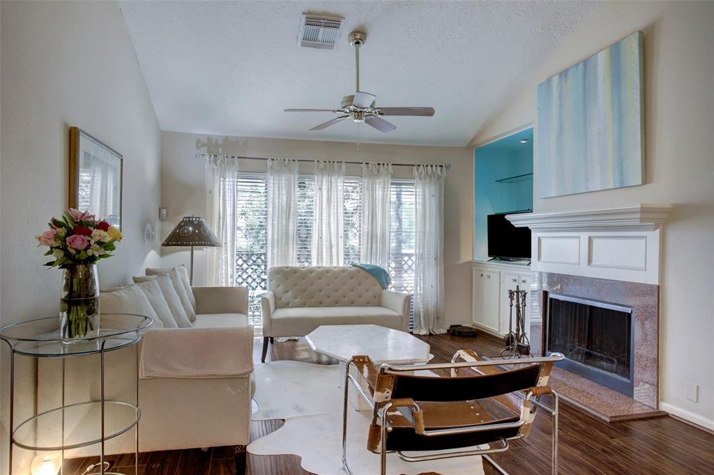 a living room with furniture a fireplace and a chandelier