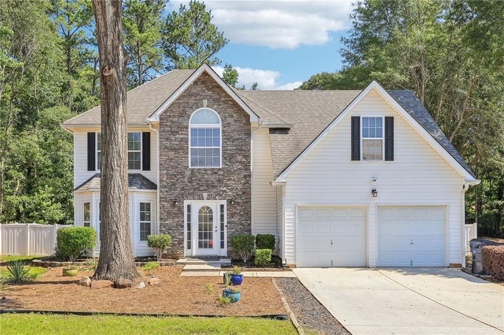 a front view of a house with a yard and garage