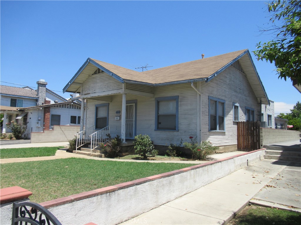 a front view of a house with a garden and plants