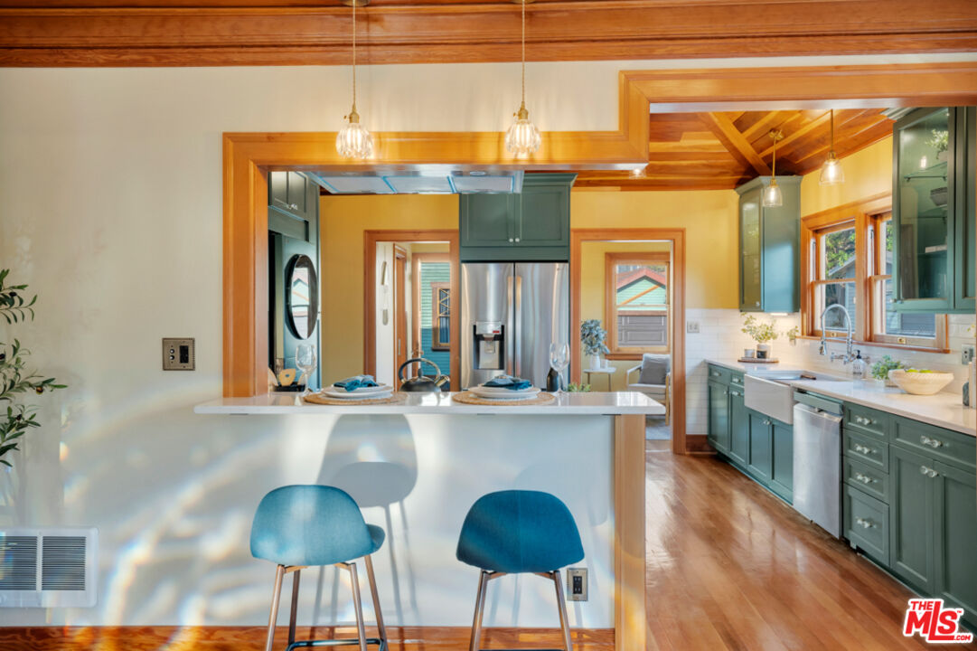 a kitchen with stainless steel appliances granite countertop a stove a sink and a wooden cabinets