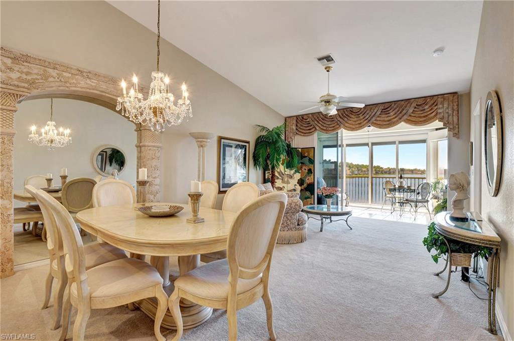 a dining room with furniture a chandelier and window