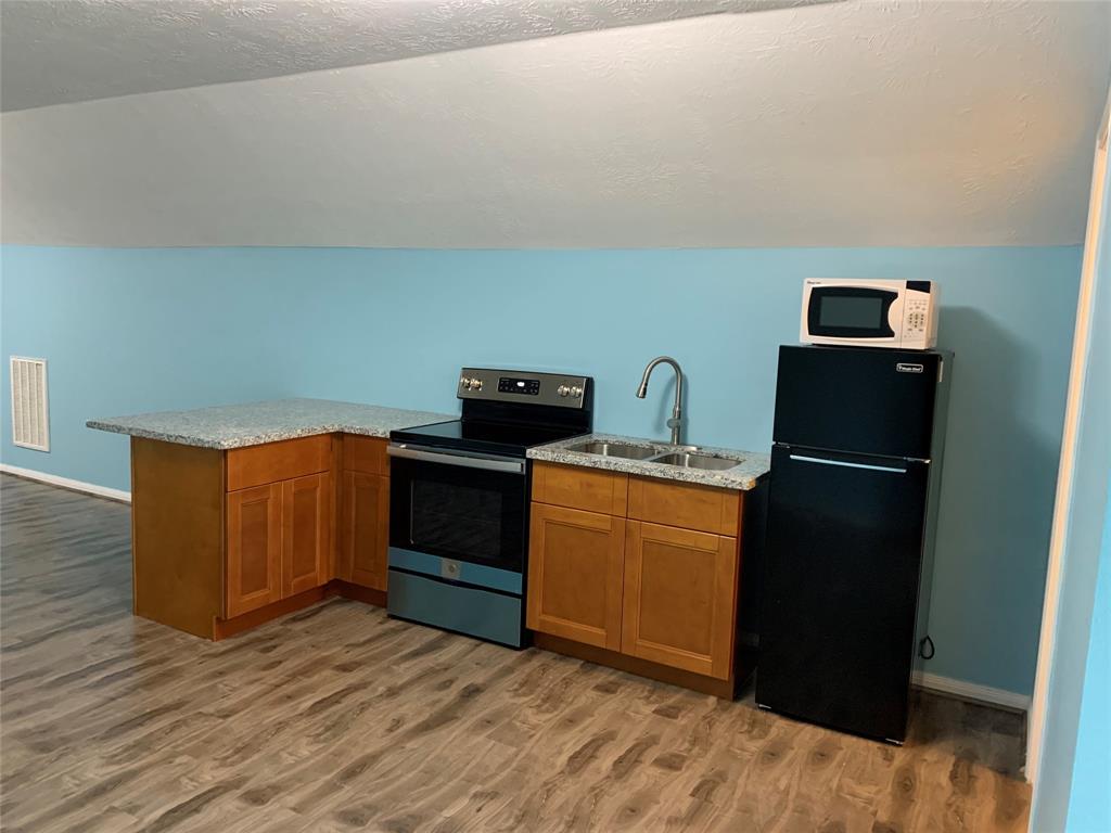 a kitchen with a refrigerator and a stove