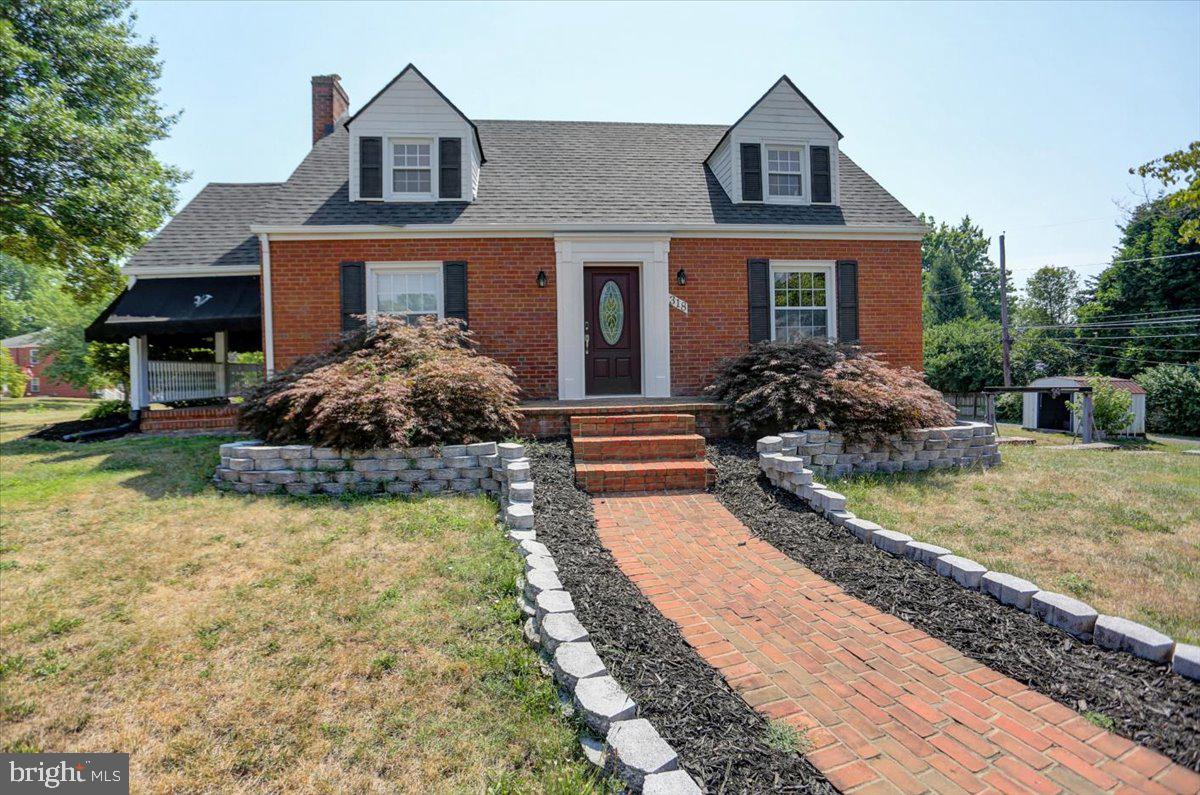 a front view of house with yard and trees around