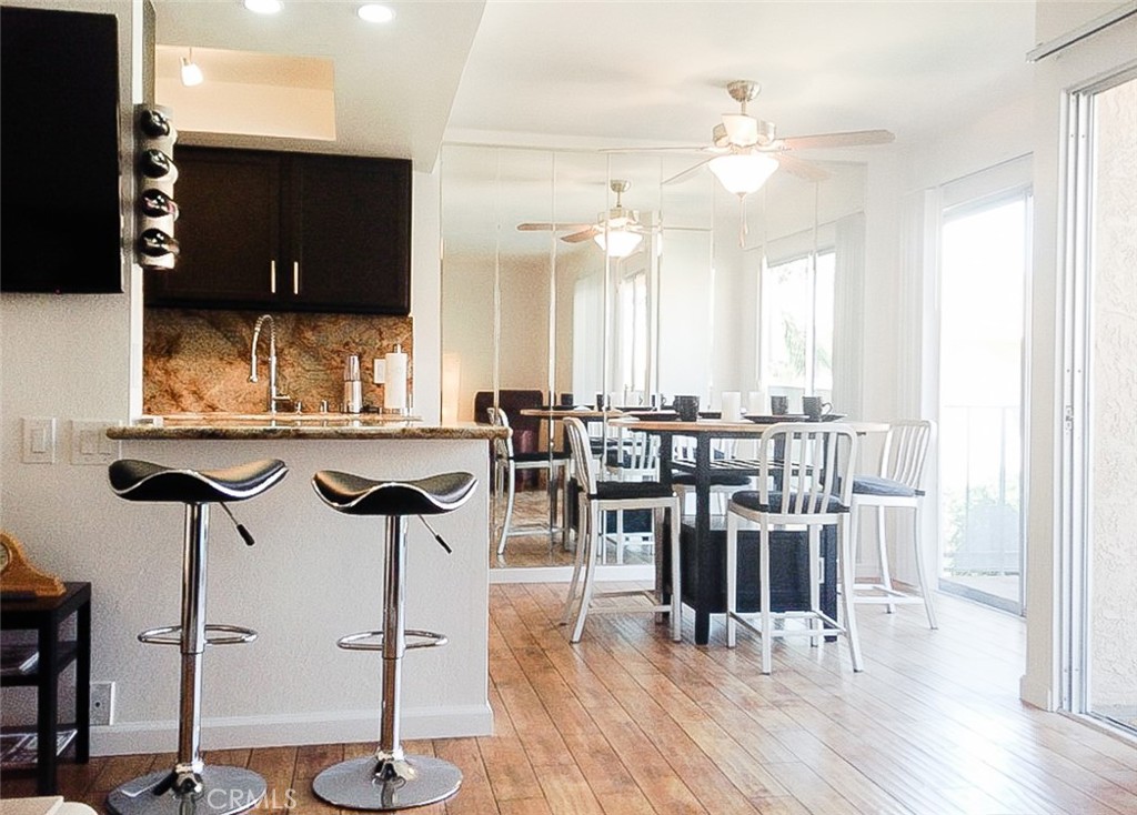 a kitchen with a table chairs and white cabinets