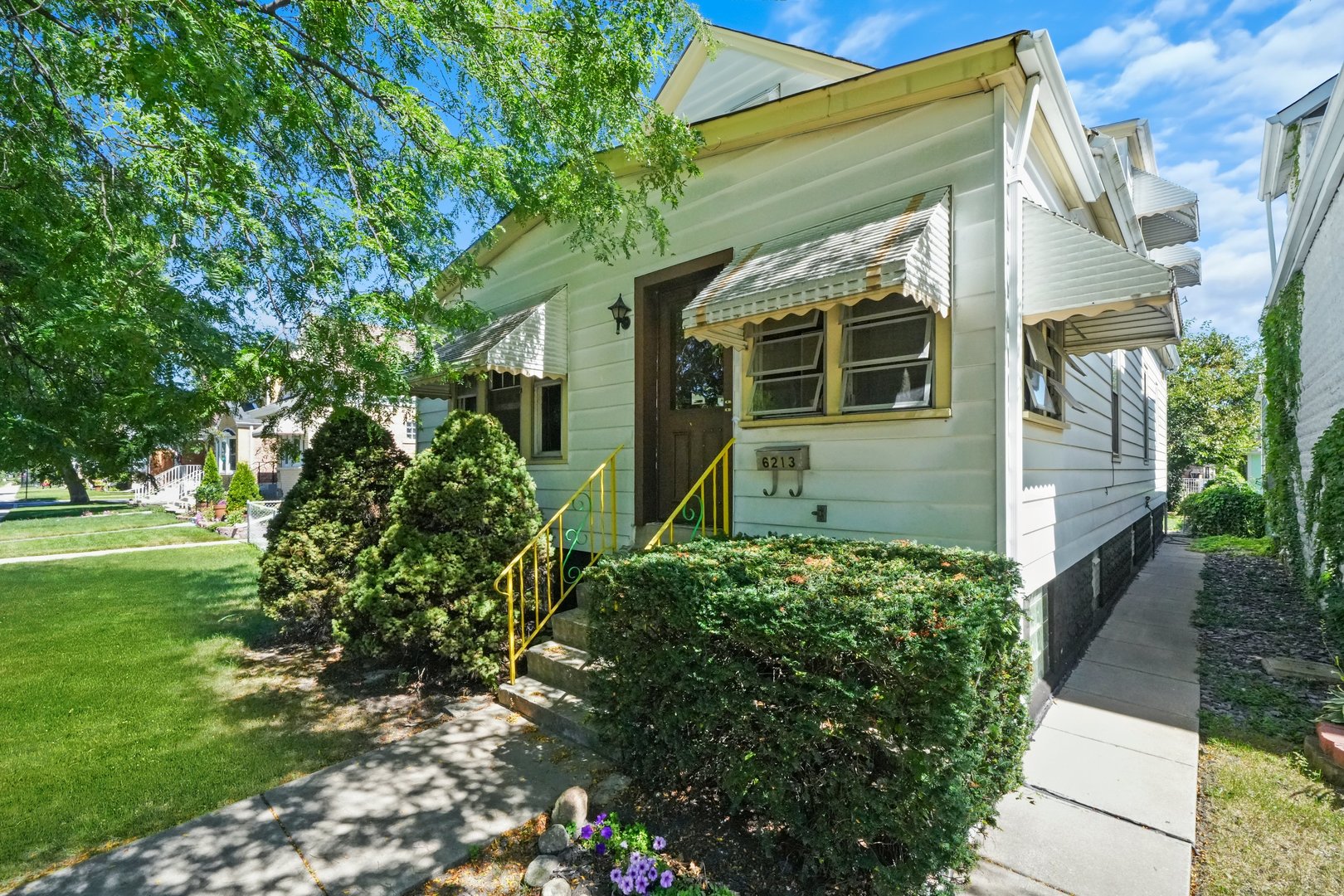 front view of a house with a garden