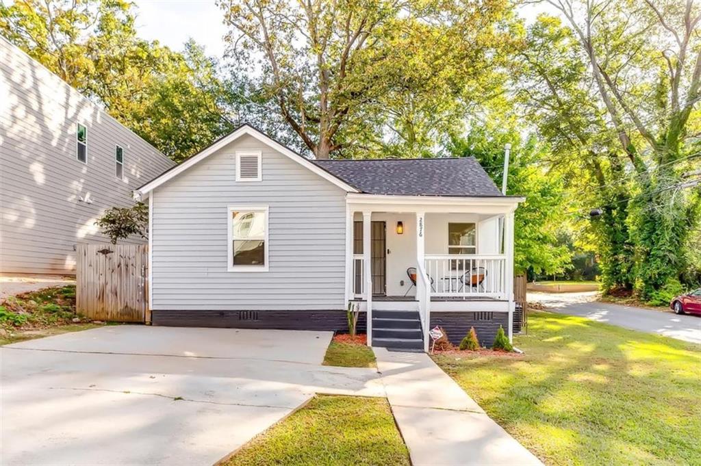 a view of house that has a yard