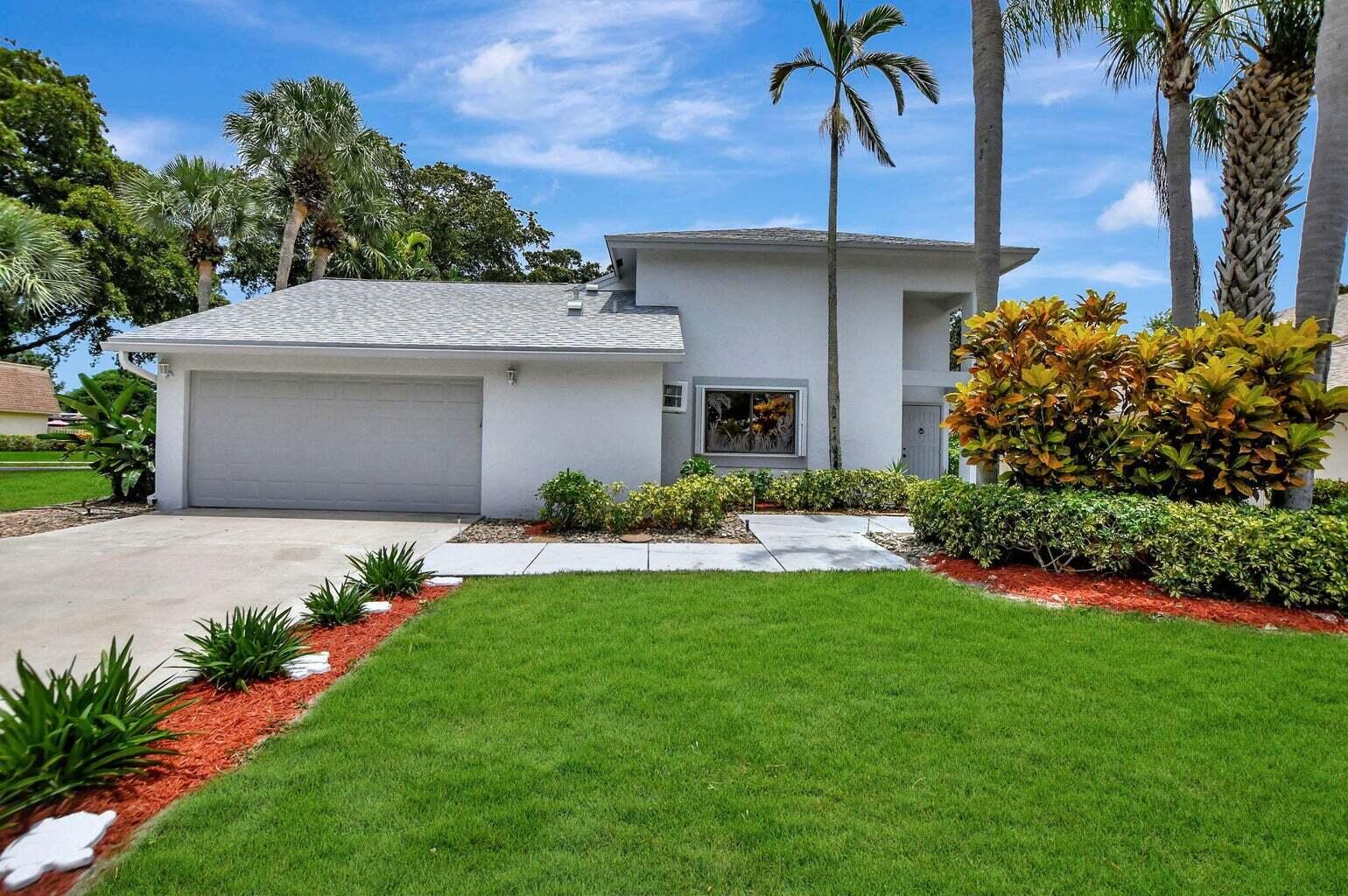 a front view of a house with a garden