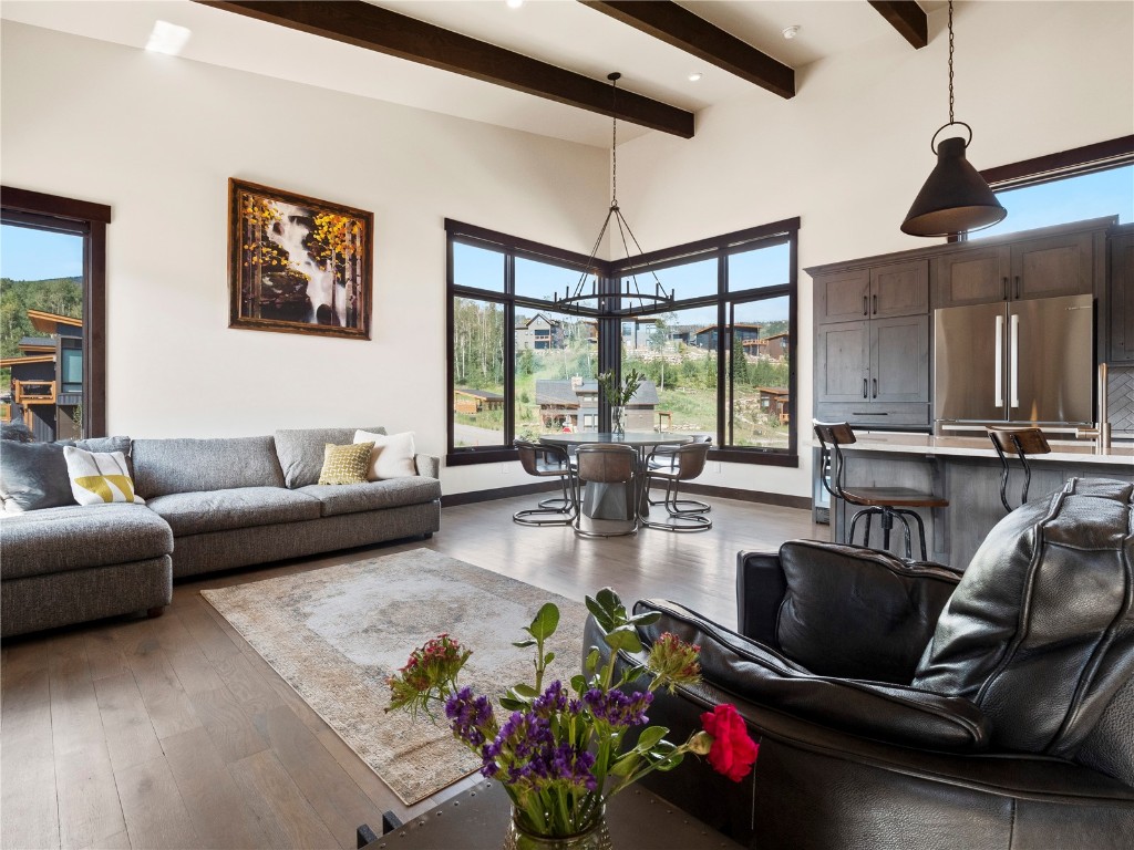 a living room with furniture fireplace and a large window