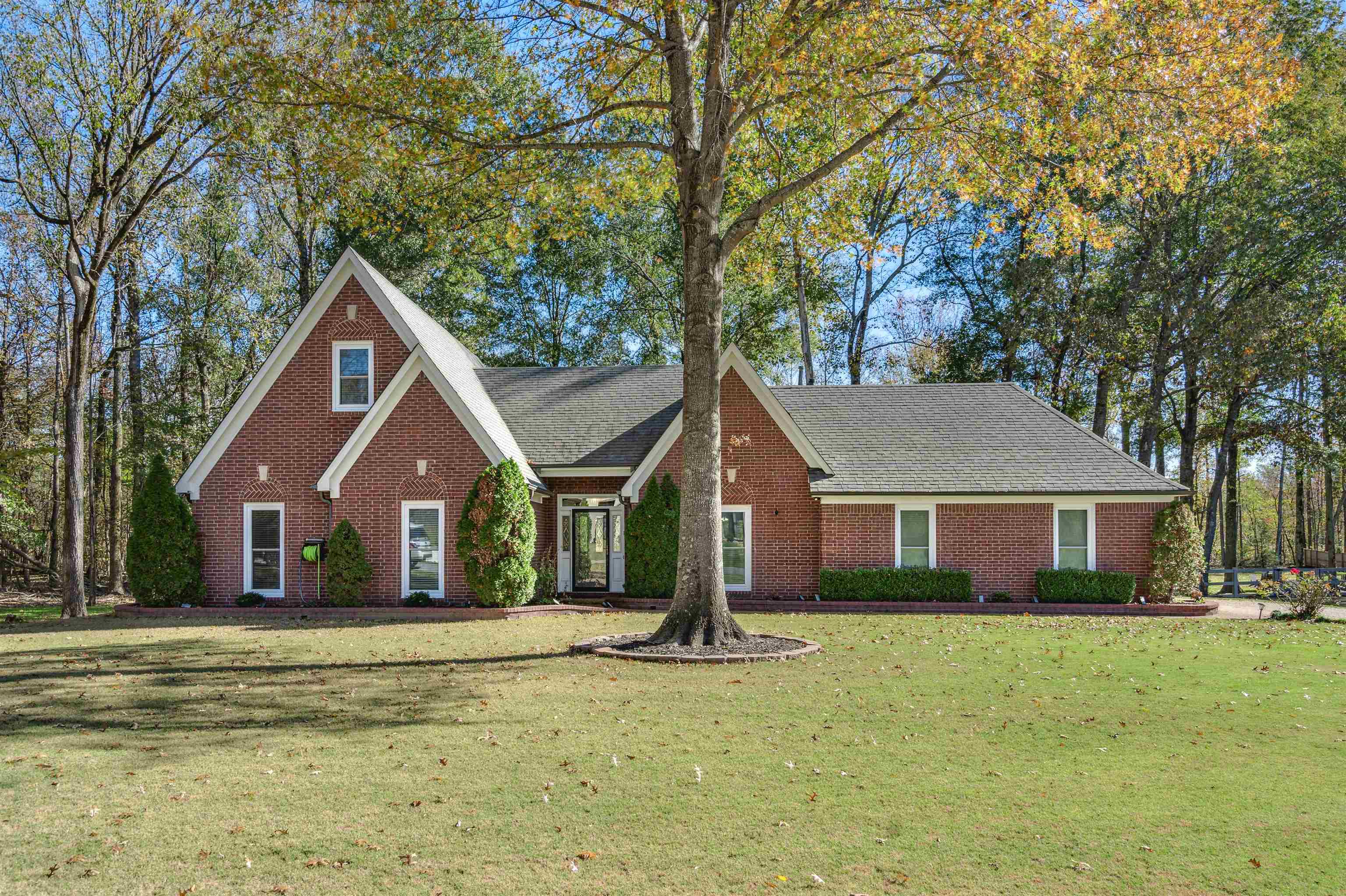 a front view of a house with a garden