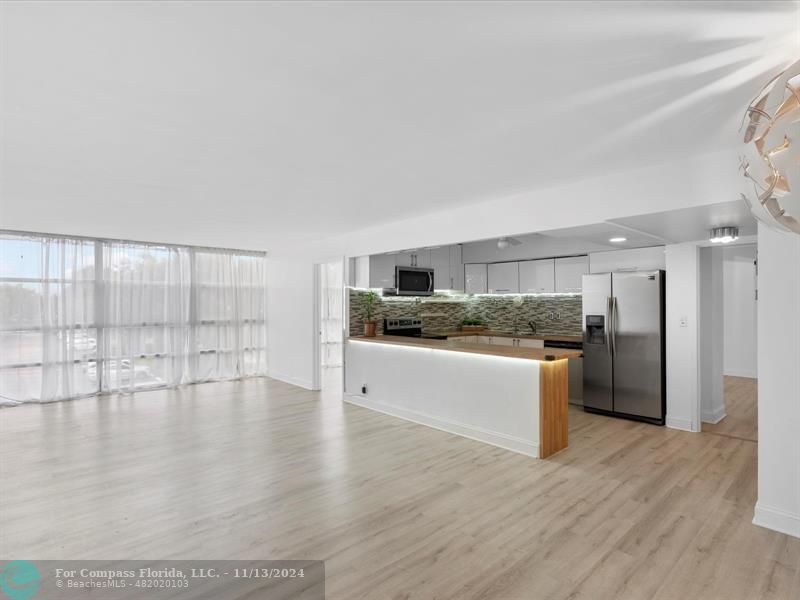 a kitchen with stainless steel appliances kitchen island wooden cabinets and granite counter tops