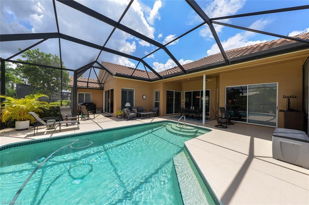 View of swimming pool with a lanai and a patio