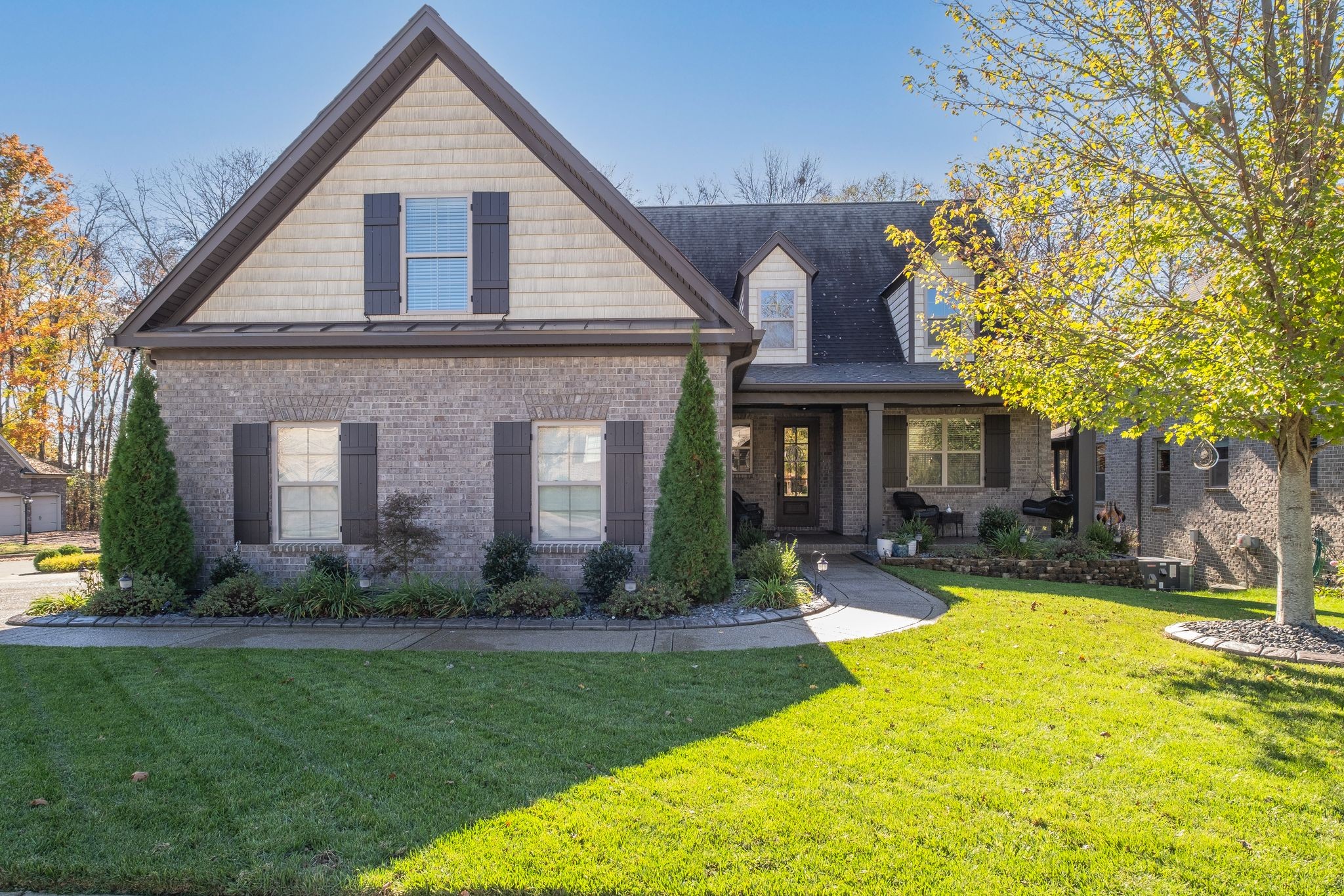 a front view of house with yard and green space